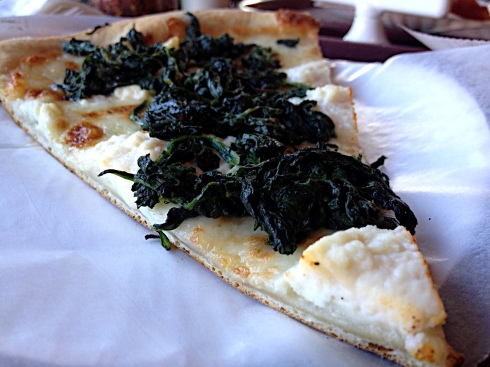 We suggest ordering spinach with your slice of white. Dollops of ricotta and a healthy sprinkling of garlic round out this excellent pizza.